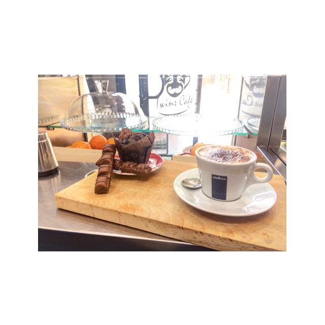 Cappuccino and pastries served on a board at Twins